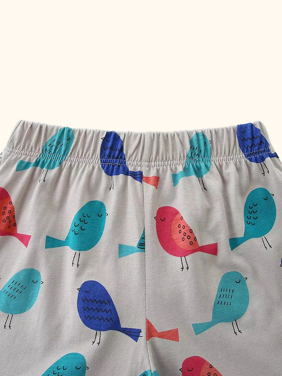 Light gray kids bird print shorts with turquoise, blue, and pink birds, waistband close-up