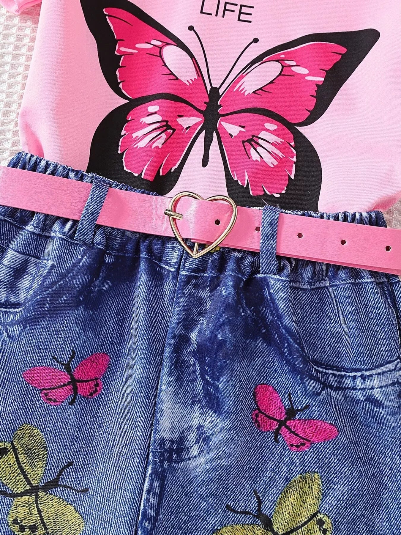 Pink kids shorts with belted waist and raw hem, detail view