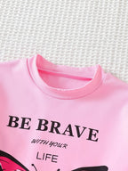Pink butterfly graphic tee with embroidered detailing, front close-up