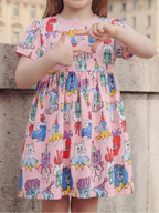 Pink kids cartoon animal print dress with playful cats and dogs, modeled front view