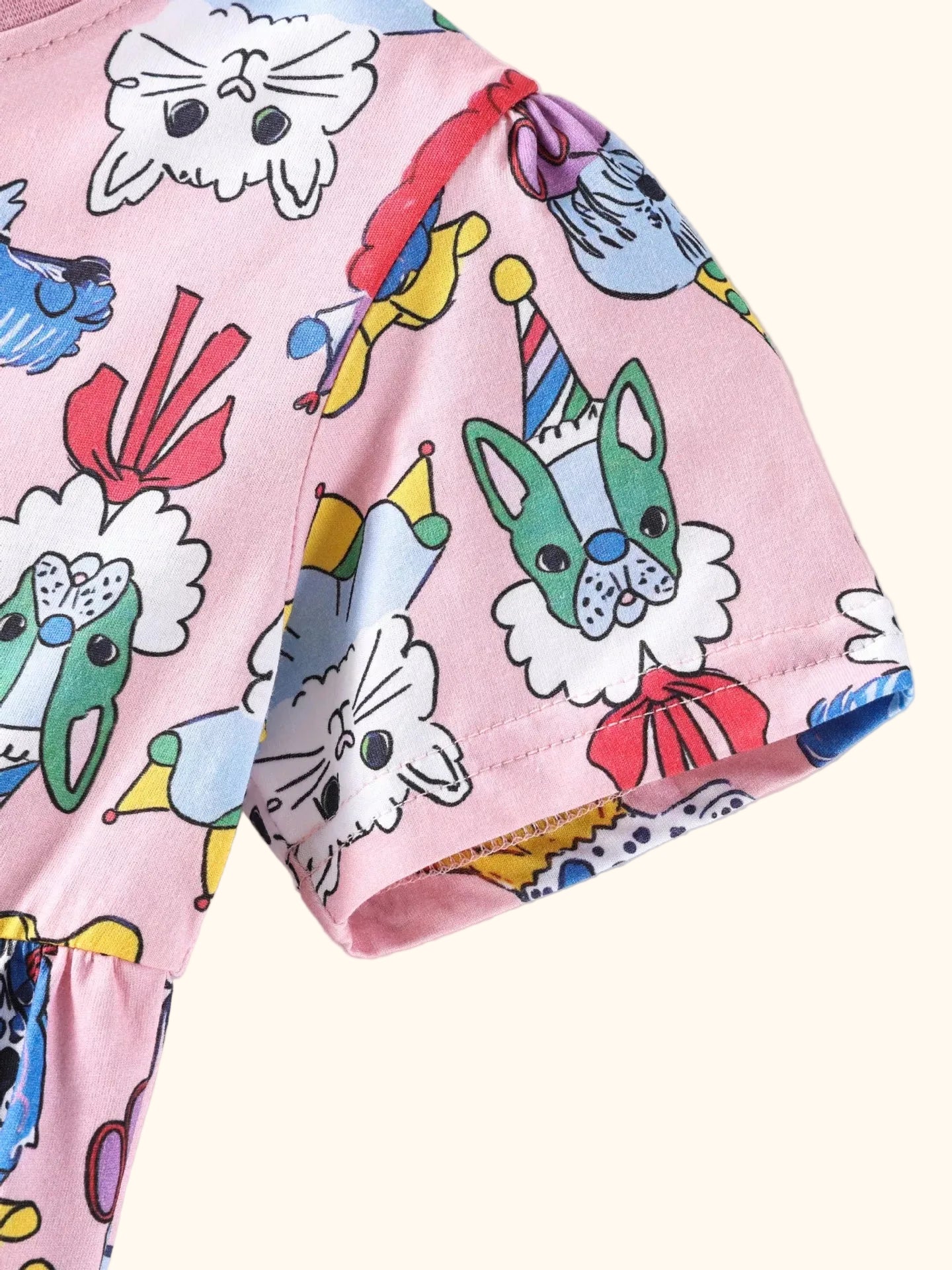 Pink kids cartoon animal print dress with playful cats and dogs, modeled front view