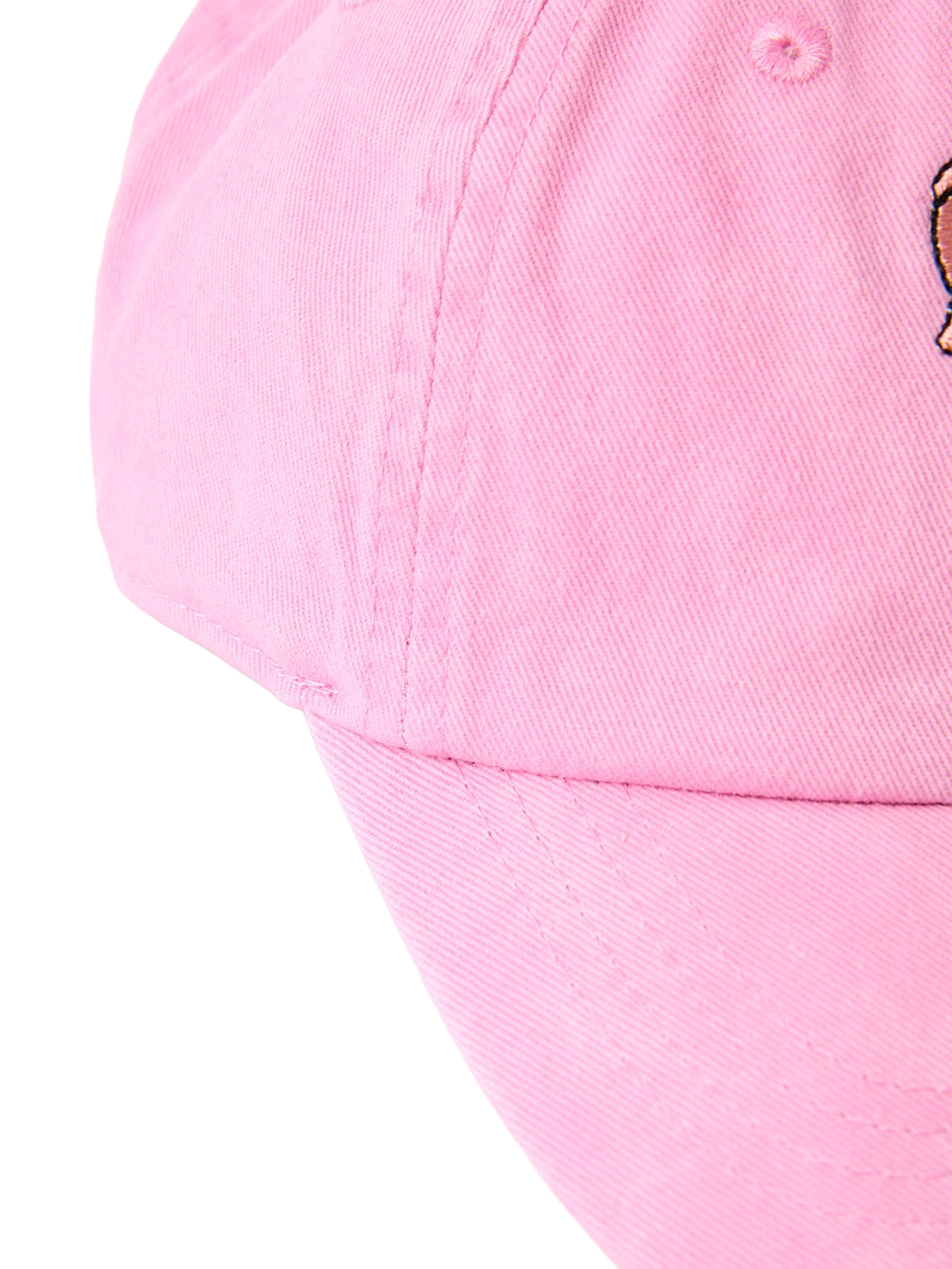 Pink kids baseball cap with curved brim and paneled stitching, side detail close-up