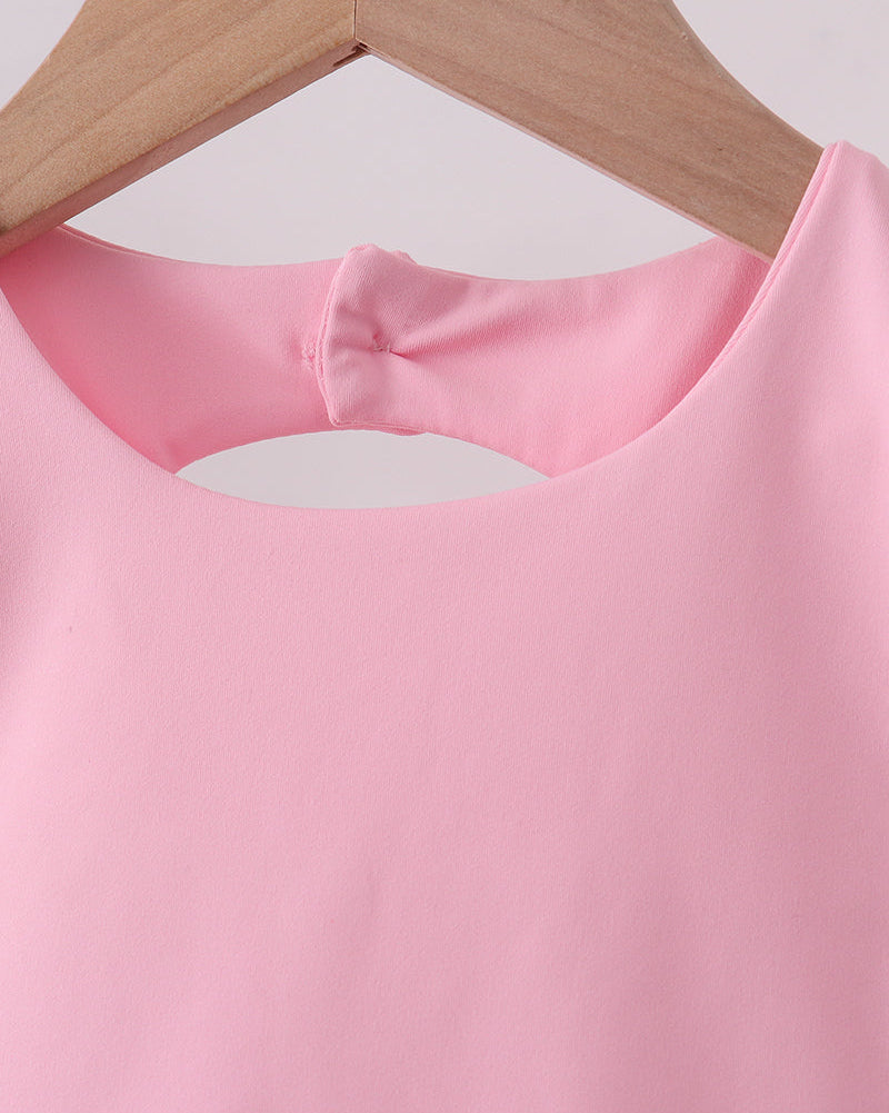 Pink sleeveless kids active top with rounded back keyhole and button closure, close-up view
