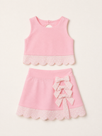 Pink kids active top and skort set with daisy scalloped trim and three bows, front product view