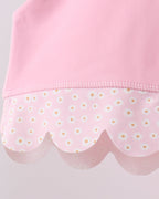 Pink kids active top with daisy-print scalloped hem, close-up detail view