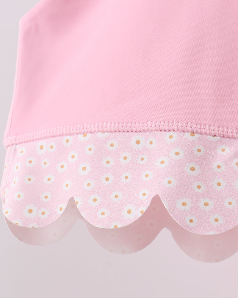 Pink kids active top with daisy-print scalloped hem, close-up detail view