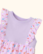 Pink kids floral dress with round neckline and flutter ruffle shoulders, bodice close-up