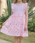 Pink kids floral ruffle gathered dress worn by child, front lifestyle view