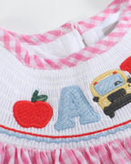 Pink gingham ABC school bishop dress with smocked embroidered neckline, front view