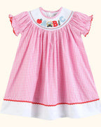 Pink gingham ABC school dress with white contrast hem band, full front view