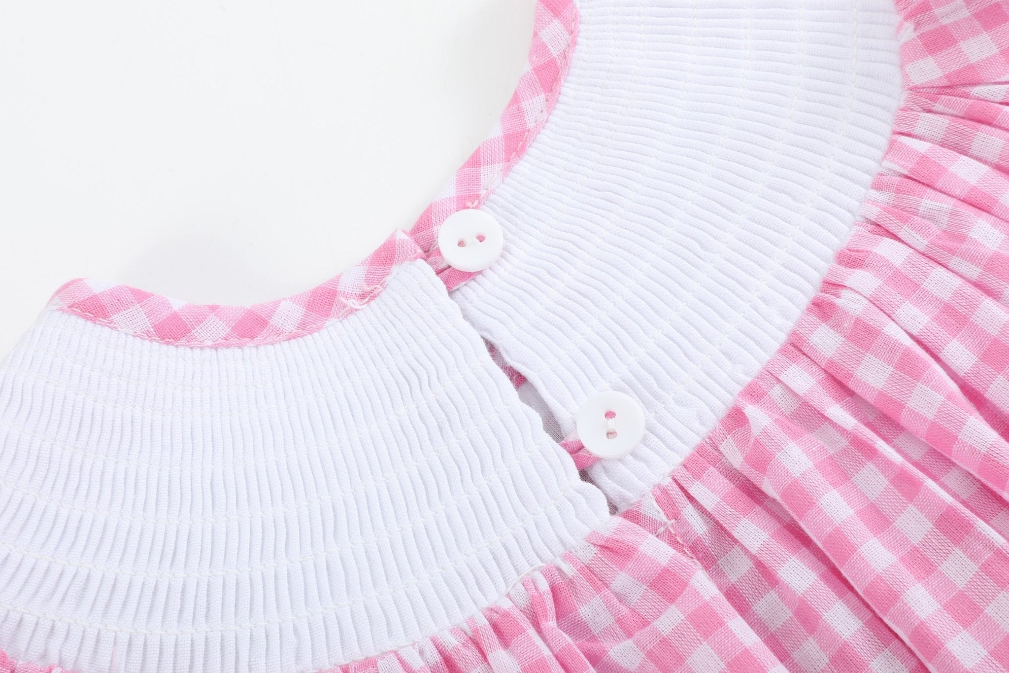 Pink gingham kids smocked bishop dress with two-button neckline closure, back detail view