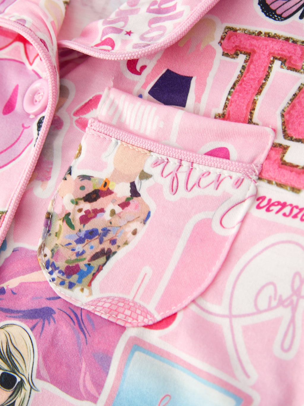 Pink kids music collage pajama top with rounded chest patch pocket and contrast piping, close-up view