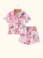 Pink kids music collage button-up pajama top and shorts set, front hanging view