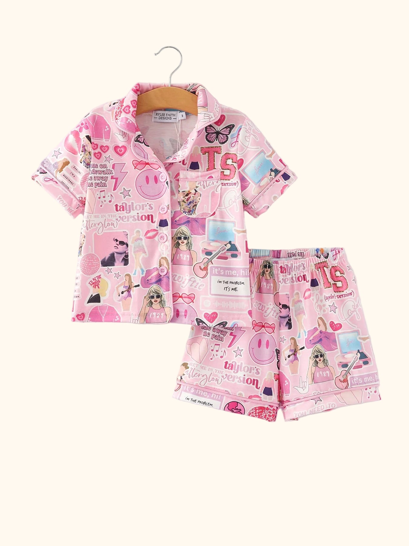 Pink kids music collage button-up pajama top and shorts set, front hanging view