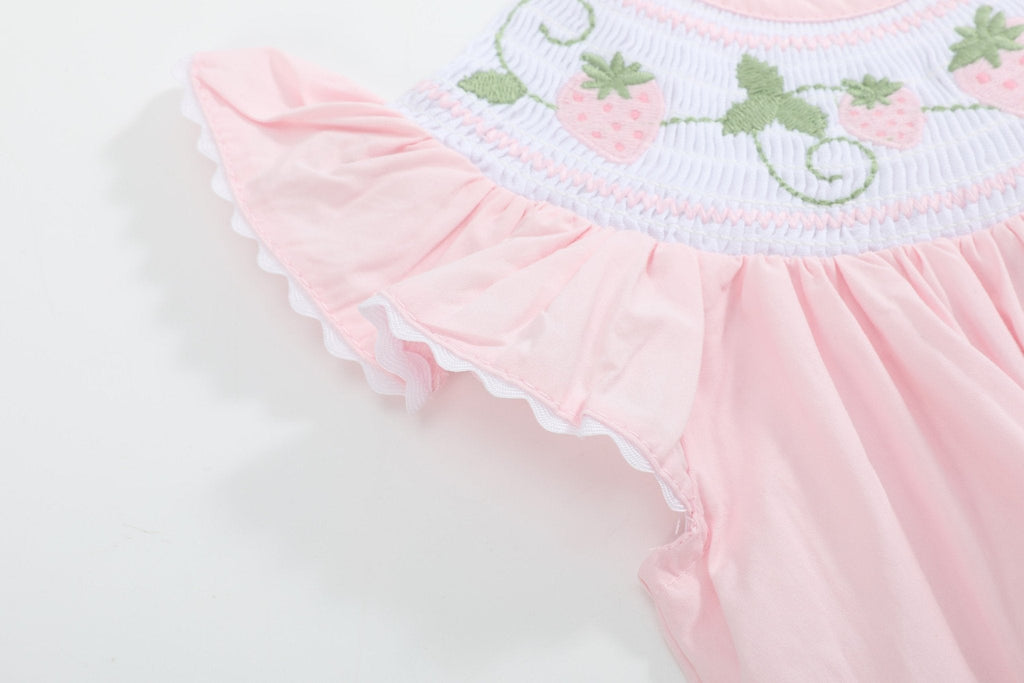 Pink baby strawberry romper with flutter sleeve and white scalloped trim, close-up view