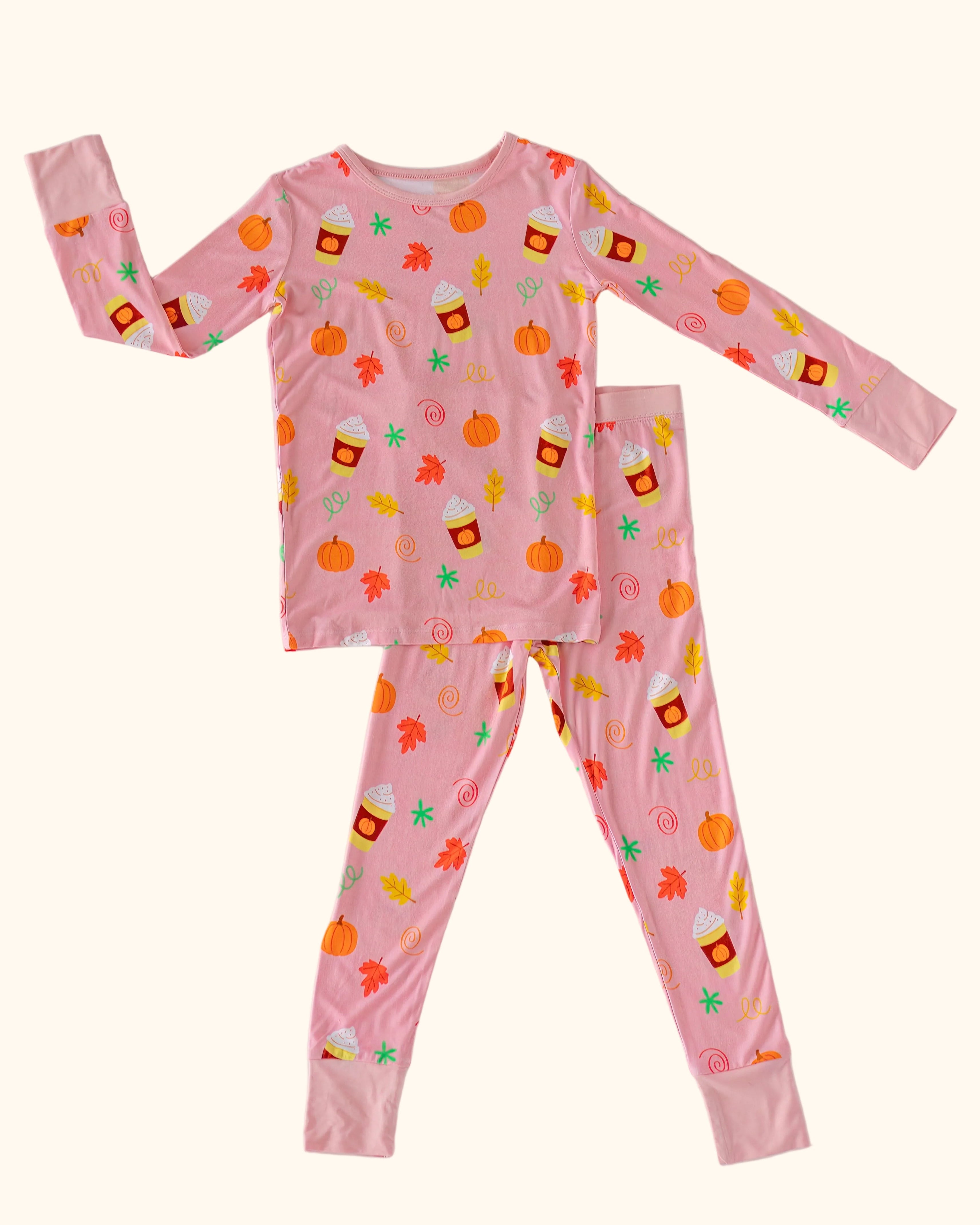 Pink kids Pumpkin Spice bamboo pajama set with pumpkins, fall leaves and drink cup print, front flat-lay view