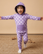 Purple checkerboard kids hooded jogger set with kangaroo pocket, modeled front action view