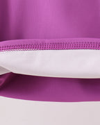 Purple performance kids activewear with reinforced seam construction, fabric detail view
