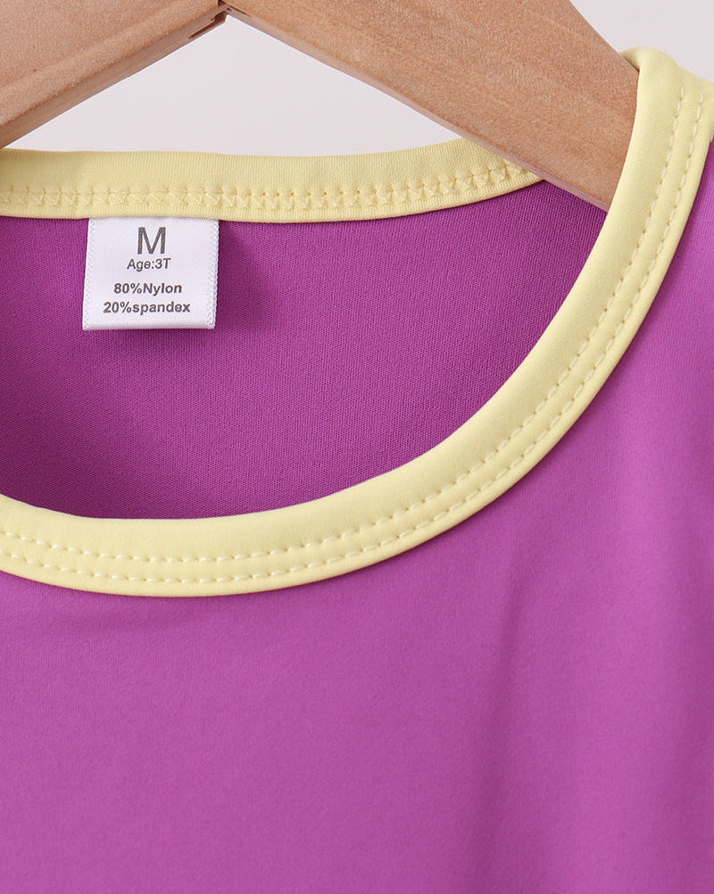 Purple sleeveless kids active tank with pale yellow neckline and arm trim, close-up view