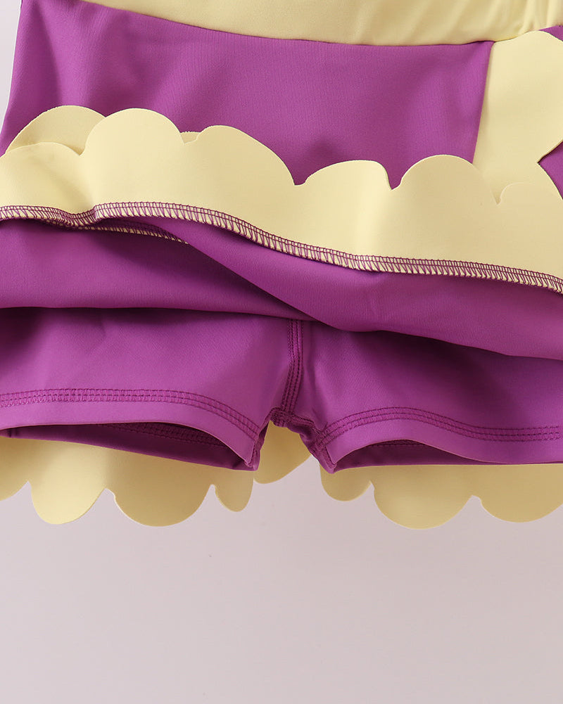 Purple kids skort with built-in fitted shorts and scalloped hem, underside detail view