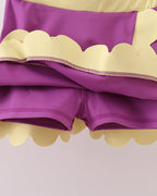 Purple kids skort with built-in fitted shorts and scalloped hem, underside detail view