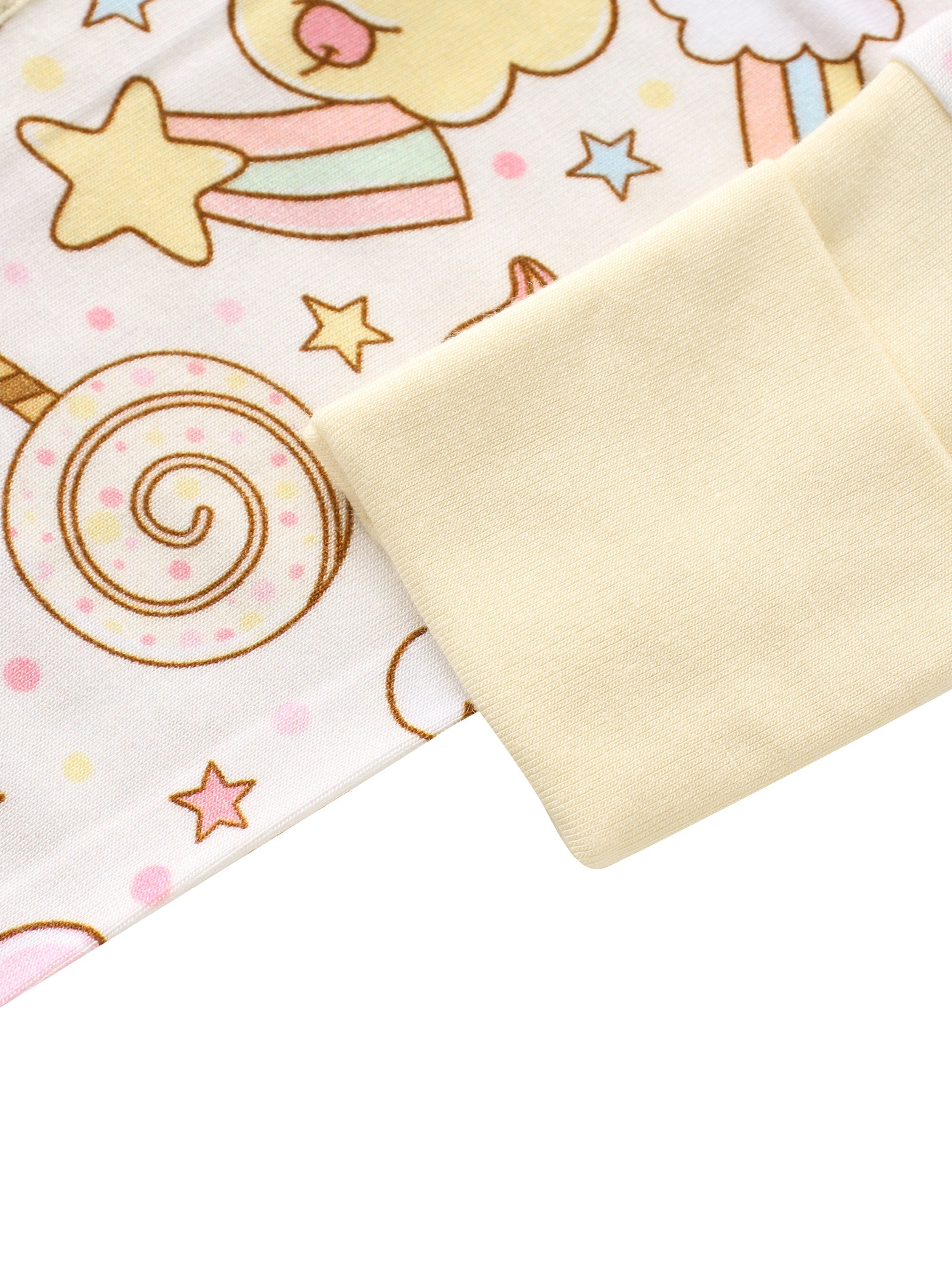 Cream baby bamboo romper with fold-over cuff and lollipop print, sleeve cuff detail