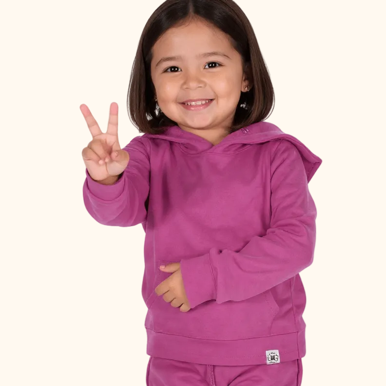 Raspberry rose kids hoodie with kangaroo pocket, front studio lifestyle view