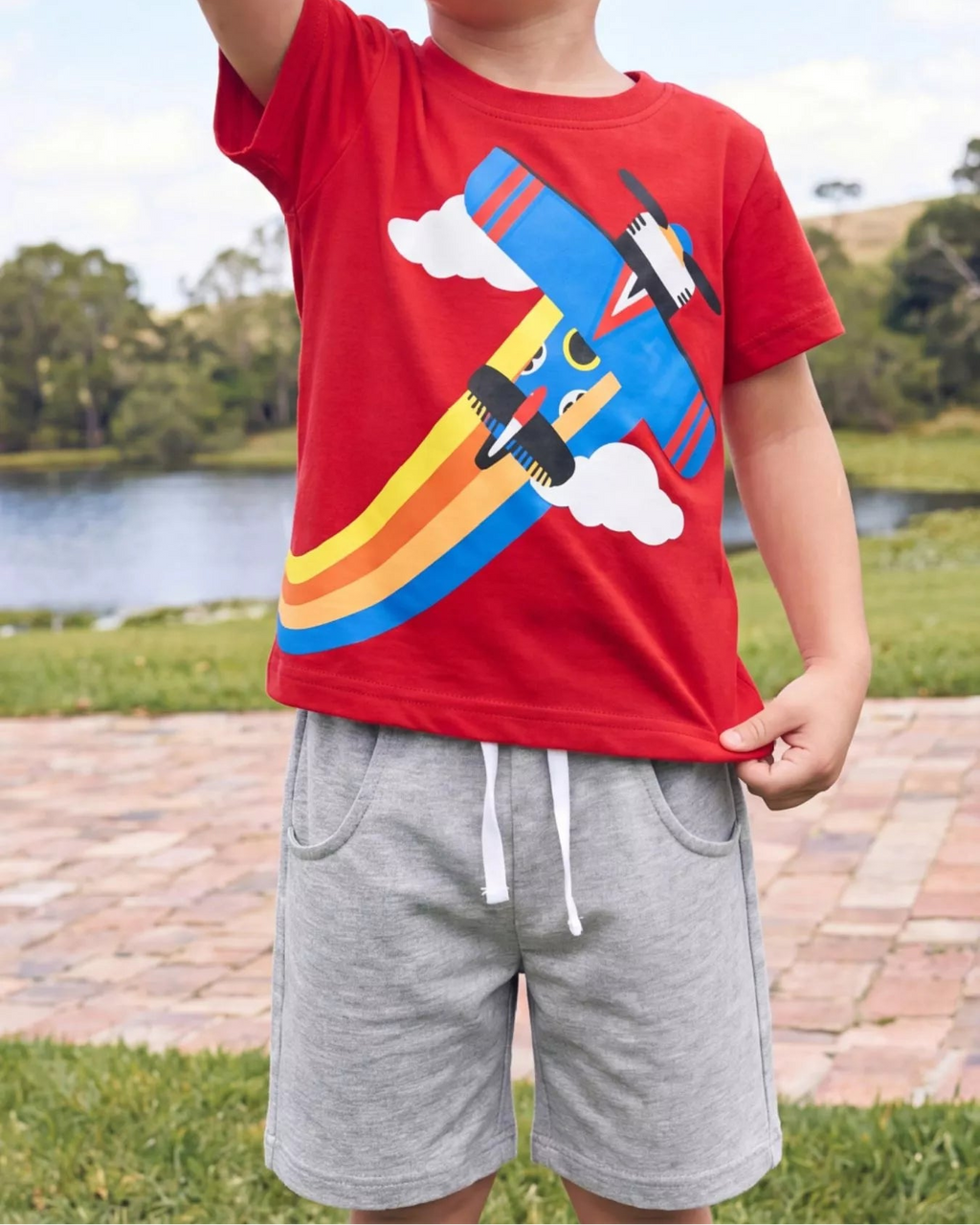 Red kids airplane T-shirt and gray drawstring shorts set, front model view