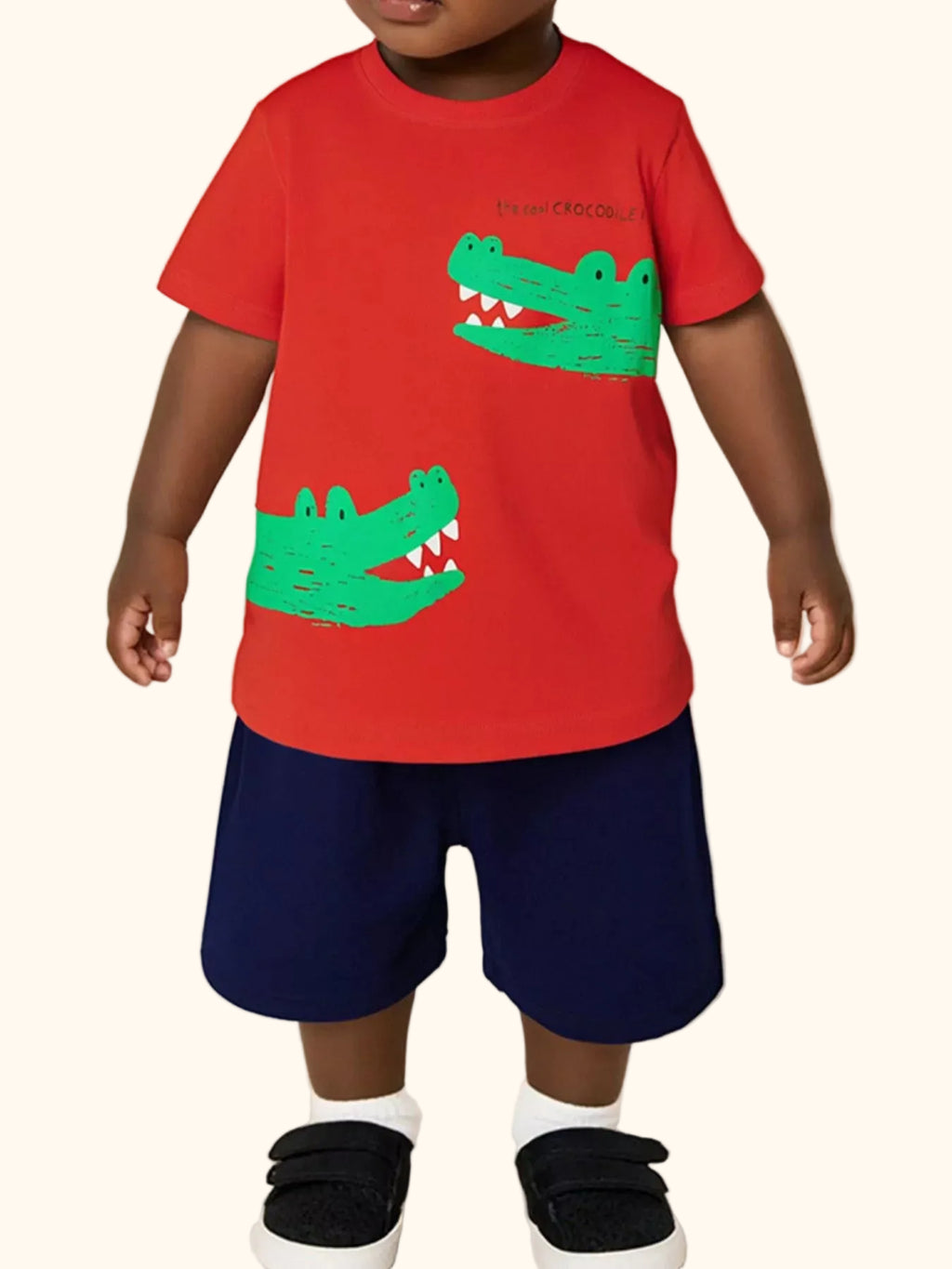Red kids crocodile graphic T-shirt and navy shorts set worn by child, front lifestyle view