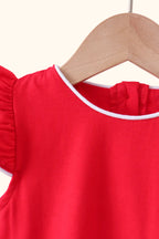 Red kids top with white-trim round neckline, close-up detail view