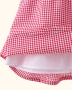 Red gingham kids dress with gathered skirt and inner lining, hem detail view