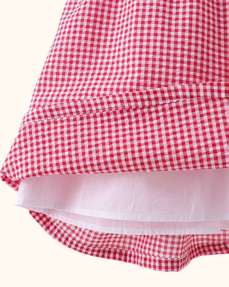 Red gingham kids dress with gathered skirt and inner lining, hem detail view