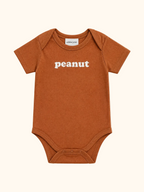 Rust brown baby organic cotton bodysuit with white peanut graphic and envelope neckline, front product view
