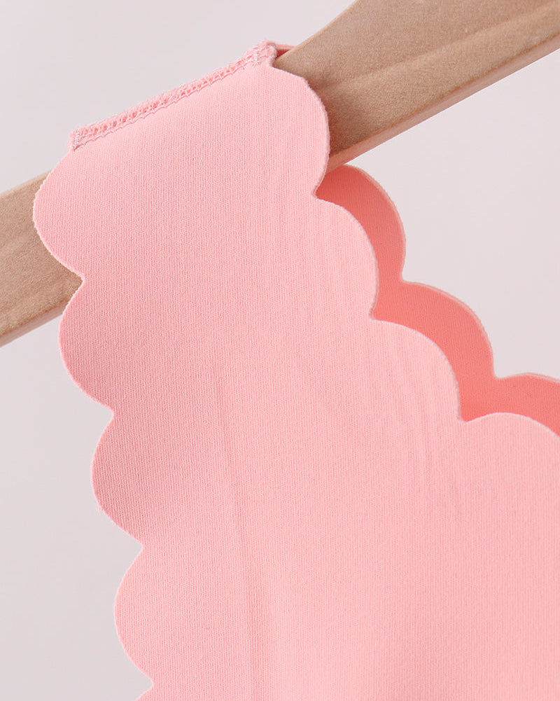 Pink scalloped active top shoulder strap, close-up detail view