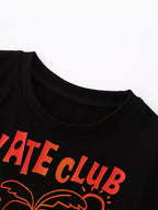 Black kids Skate Club T-shirt with round neckline and orange graphic lettering, neckline close-up