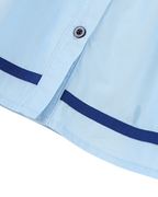 Sky blue kids button-front dress with navy contrast stripe, hem and button close-up