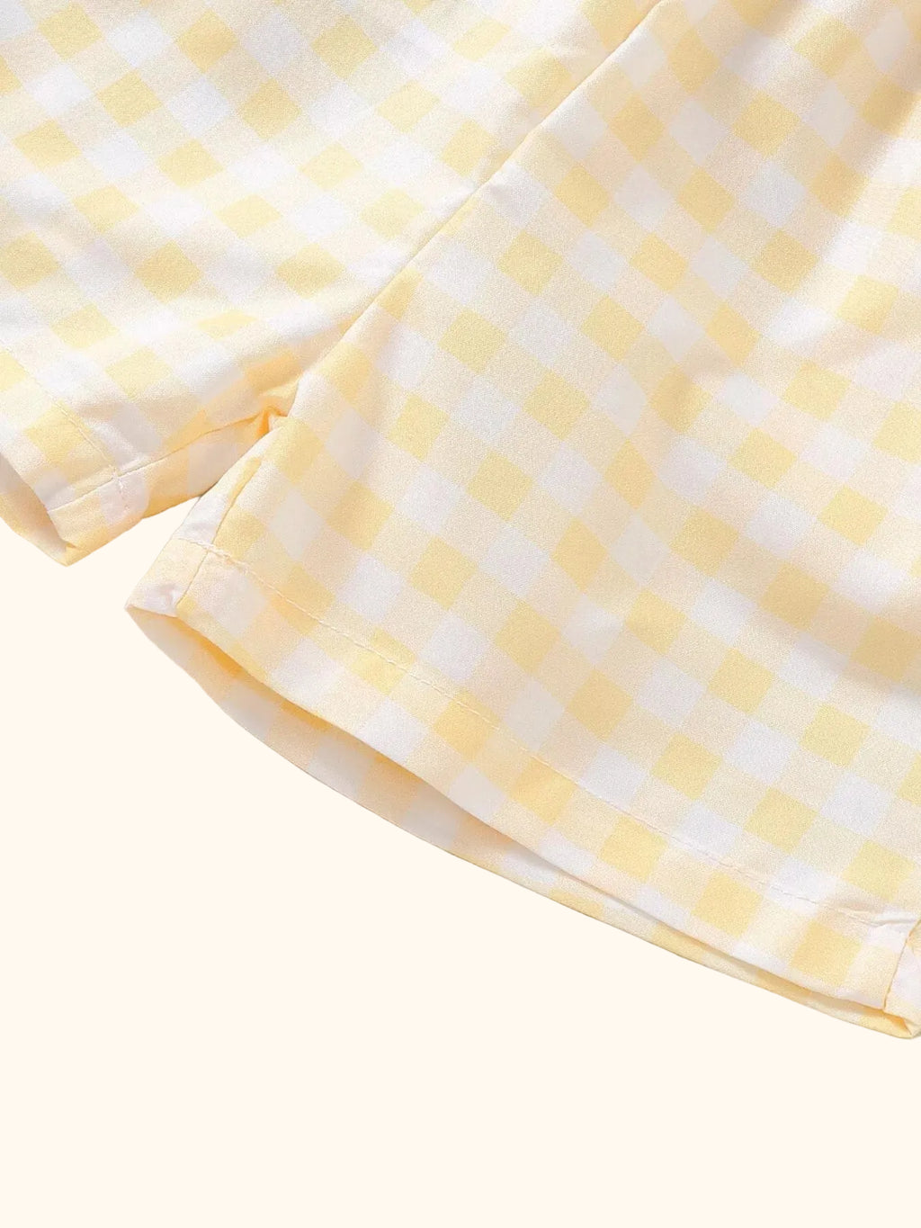 Yellow and white gingham baby shorts with straight hems, fabric detail view