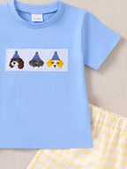 Sky blue baby short-sleeve tee with embroidered puppy patch and gingham shorts, close-up view