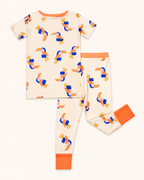 Cream kids toucan bamboo pajama set with orange waistband and ankle cuffs, back flat-lay view