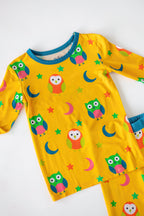 Yellow kids bamboo pajama set with colorful owls moons and stars, top detail view