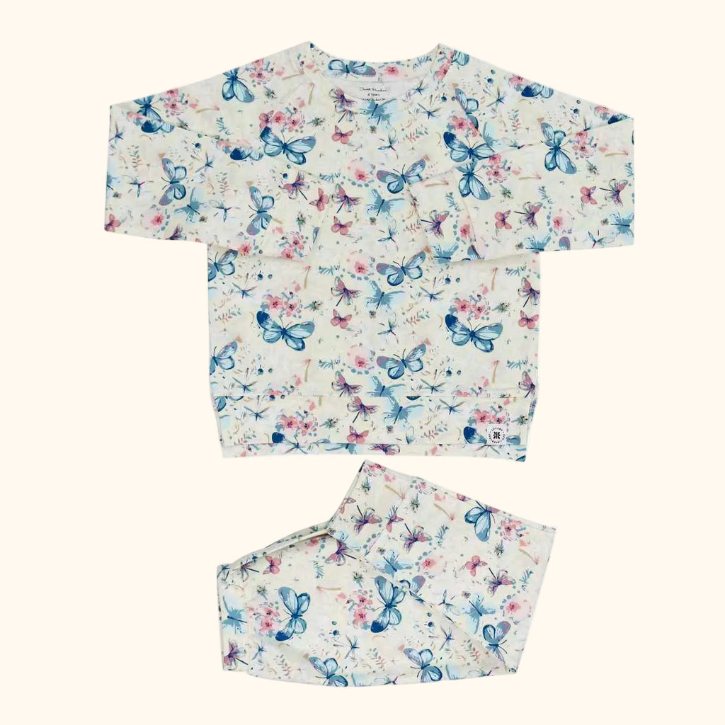 Ivory butterfly floral crew neck pocket top and matching kids jogger pants, flat lay front view