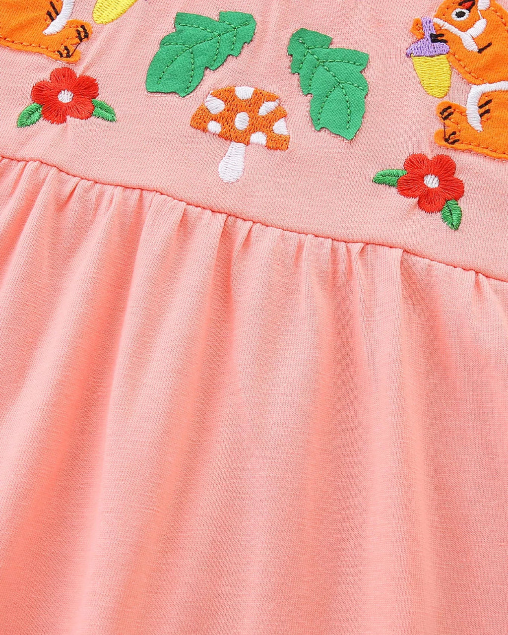 Watermelon pink kids embroidered dress with mushroom, flowers, and gathered waist, detail view