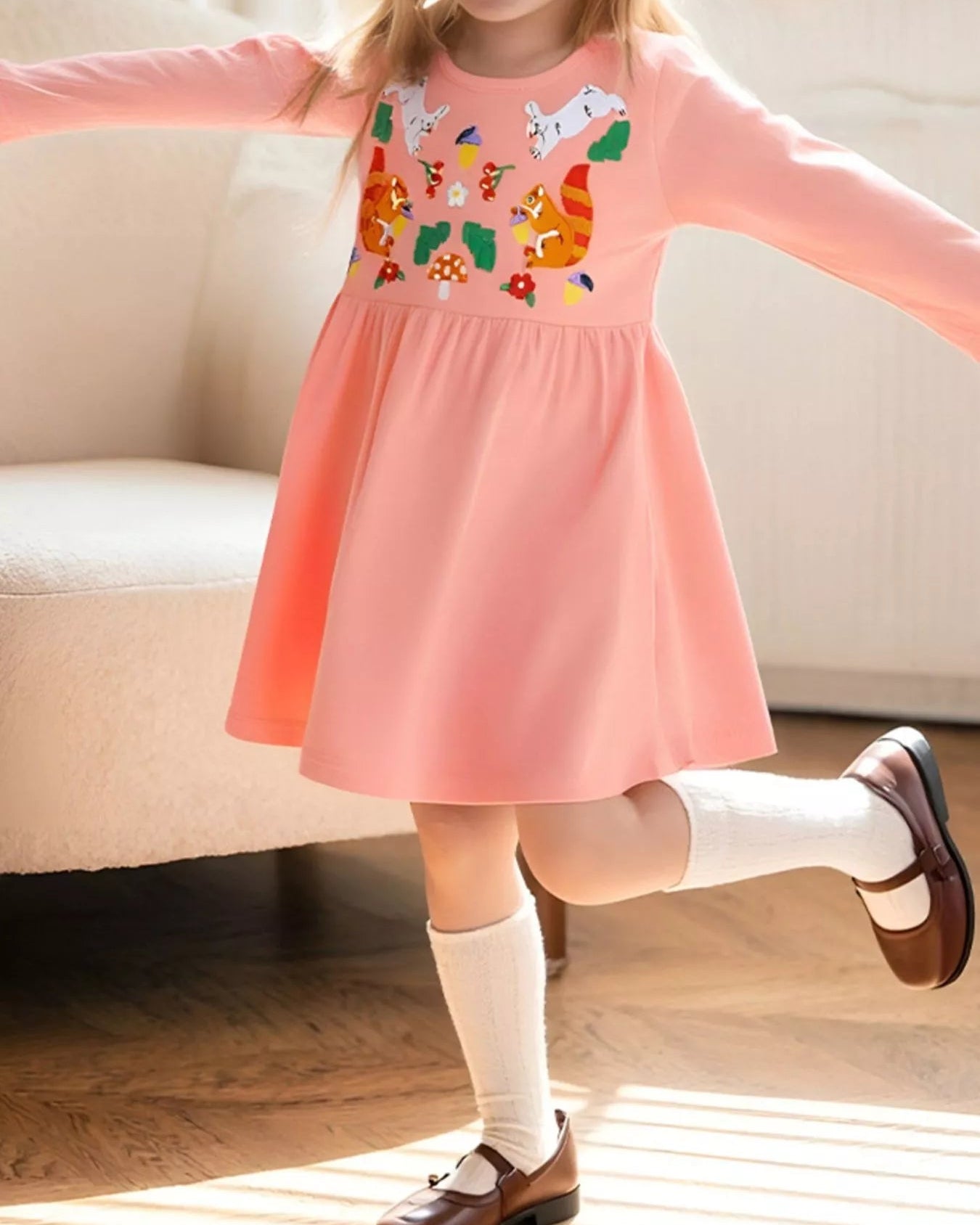 Watermelon pink kids animal embroidered long sleeve dress worn by child, front lifestyle view