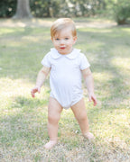 White Peter Pan collar baby bodysuit, modeled front view
