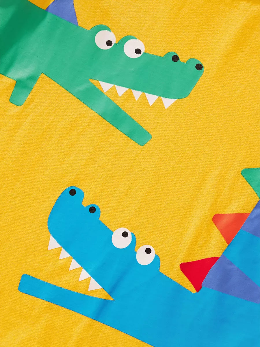 Yellow kids T-shirt with green and blue crocodile graphics, front design close-up