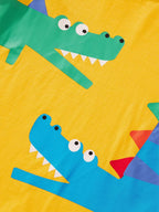 Yellow kids T-shirt with green and blue crocodile graphics, front design close-up