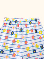 White kids striped floral shorts with colorful flowers and elastic waistband, close-up view