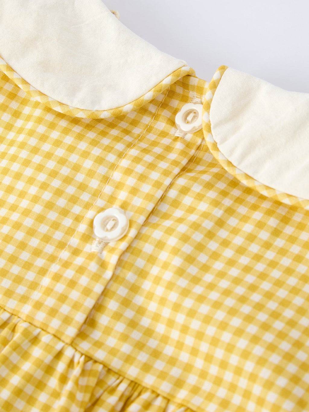 Yellow kids gingham dress with white back buttons and Peter Pan collar, back detail