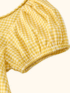 Yellow gingham kids smocked goose dress with gathered skirt, full front view