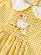 Yellow kids gingham dress with white Peter Pan collar and puff sleeve, neckline detail